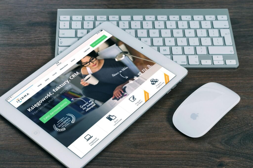 ipad-mockup-apple-business-39559-39559 A tablet with a financial website open, alongside a white keyboard and mouse. Ideal for tech-theme stock images.
