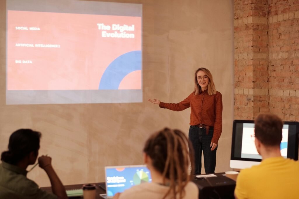 pexels-photo-6476783-6476783 Young woman presenting on digital evolution concepts like AI and big data in a seminar.